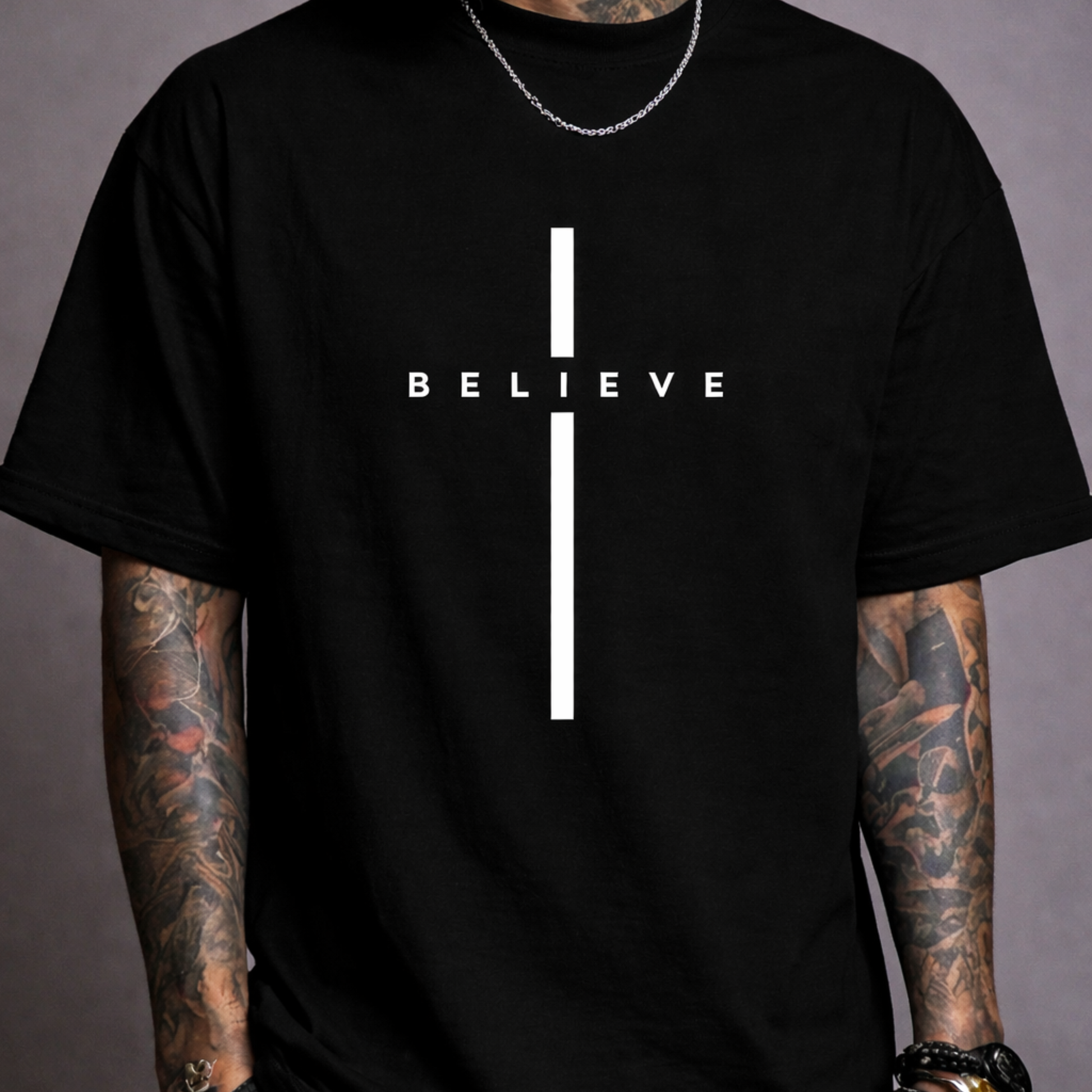 Oversized black t-shirt with minimalist ‘BELIEVE’ cross design, modern Christian streetwear