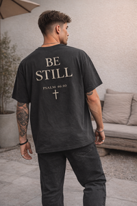 Oversized vintage black t-shirt with ‘Be Still’ faith design