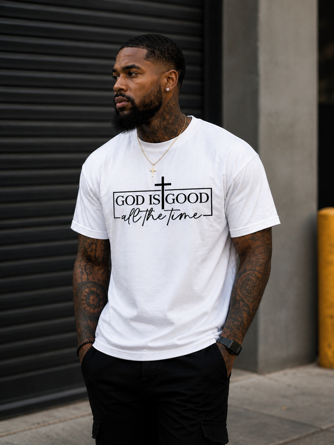 White Christian graphic t-shirt featuring God Is Good All The Time design with cross and minimalist black lettering.