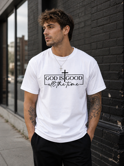White Christian graphic t-shirt featuring God Is Good All The Time design with cross and minimalist black lettering.